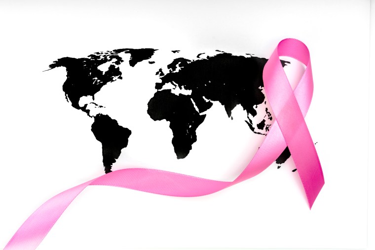 World cancer day : Breast Cancer Awareness Ribbon on world map .